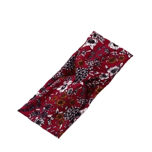 Floral twist knot headband in burgundy with orange patterns for yoga and sports