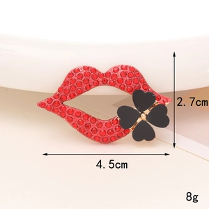 Close-up of a red lip brooch with black clover and crystal rhinestones, 4.5cm wide