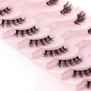 Close-up of black half-eyelash clusters on a pink tiered display tray for volume effect