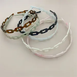 Group shot of colorful acetate chain headbands in tortoise, green, white and pink