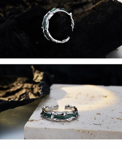 Detailed view of silver irregular lava ring with deep green enamel on stone base