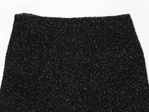Gros plan détaillé sur la texture du tissu en tweed noir et blanc et le motif tissé