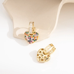 Detail of gold heart earrings showing rainbow zircon stones and hollow heart pattern back