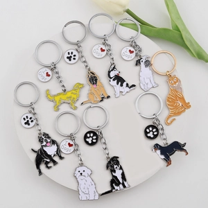 Collection of colorful enamel dog breed keychains with I Heart Dogs charms on a white stand