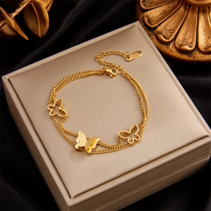 Double-layered gold stainless steel chain bracelet with butterfly pendants on jewelry box