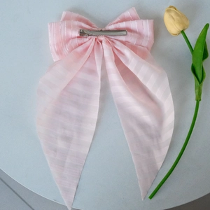 Pink striped fabric bow hair clip with long mesh ribbons and metal duckbill clip detail