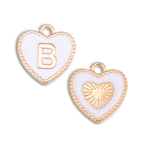 Macro detail of white enamel heart charms with gold initial B and radiant heart pattern