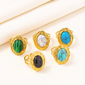 Detailed macro view of five vintage adjustable rings with colorful bohemian gemstones
