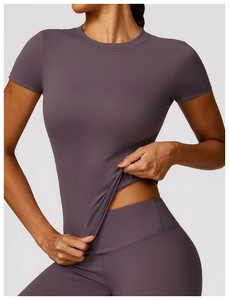 Detail of purple high-stretch seamless yoga set featuring a slim-fit crew neck top