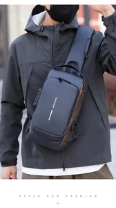 Detail of blue sling bag with anti-theft combination lock and side USB charging port