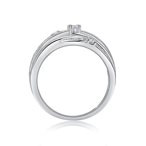 Macro detail of silver ring featuring crisscross bands and fine pave gemstone settings