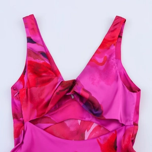 Detail of satin floral halter dress with deep V-neck, front knot and waist cutout