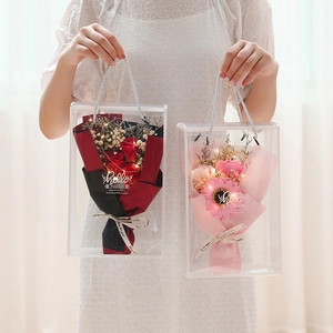 Detail of soap rose and sunflower bouquets with LED lights in clear gift bags