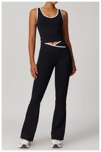 Detail of high-waist yoga pants with V-shaped crossover waist and white contrast piping
