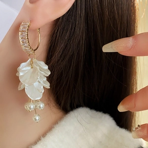 Detail of zircon petal earrings with cascading pearls and gold-plated floral accents