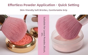 Detailed view of dense pink bristles of a makeup brush dipping into loose powder