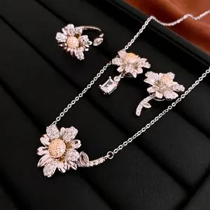 Elegant silver daisy jewelry set with white and yellow zircons in a black display box