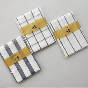 Detail showing blue and white waffle weave kitchen towels in retail packaging