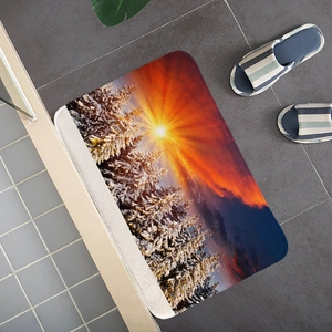 Macro view of snow forest flannel bath mat with vibrant sunset landscape and anti-slip texture