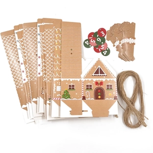 Flat lay of DIY kraft paper Christmas house gift boxes with number labels and twine rope