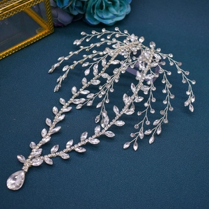 Close-up of silver bridal headband with crystal leaves and a teardrop rhinestone pendant