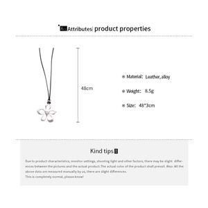 Detailed view of silver flower pendant on black leather cord with size specifications