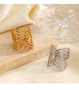 Detail of 18K gold and silver layered geometric open rings on a stone plate