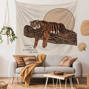 Morandi tiger tapestry with inspirational quote hanging over a sofa in a cozy room