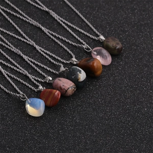 Multiple irregular natural crystal stone necklaces with silver twist rope chains on black