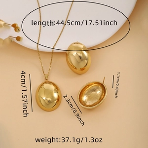 Detail view of golden hemispherical jewelry set showing dimensions and polished finish