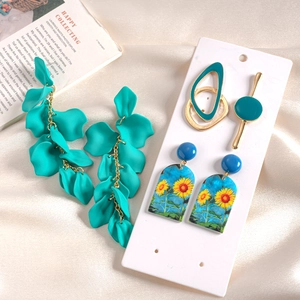 Six-piece set of acrylic geometric drop earrings in teal and gold with floral art