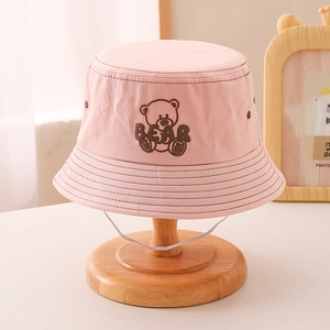 Detailed embroidery of a brown bear and BEAR text on a pink cotton children fisherman hat
