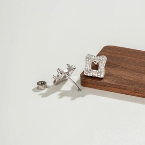 5mm square geometric silver stud earrings with sparkling cubic zirconia on a wood board
