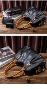 Detailed view of the 4-piece black PU leather handbag set with gold hardware and brown handles