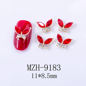 Detailed view of red 3D butterfly nail charms with marquise rhinestones and gold base