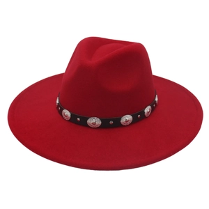 Detailed view of red wide brim fedora hat with black band and silver concho accents