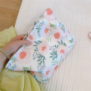 Macro detail of floral cotton makeup bag with pink peonies and secure zipper