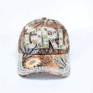 Detail of floral baseball cap with white pearls and GIRL rhinestone lettering