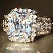 Macro shot of rectangular radiant cut zircon ring with triple row pavé setting