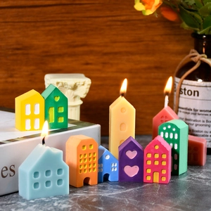 Handcrafted miniature house shaped colorful candles for festive home decor scenery