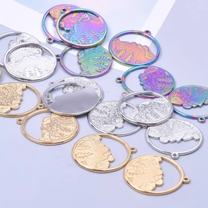 Macro shot of circular hollow mountain pendants in gold, silver and rainbow plated steel