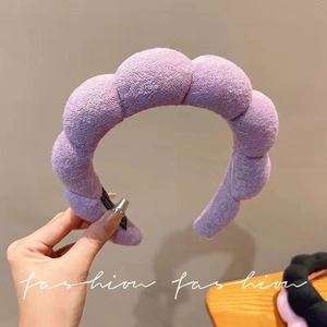 Close-up of thick purple sponge headband showing plush terry cloth texture for skincare