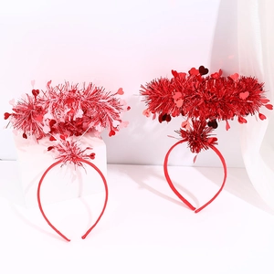 Close-up of Valentine's Day heart headbands with red sequins and metallic tinsel wire