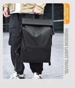Detail of waterproof black roll-top backpack with buckle straps and a side zip pocket