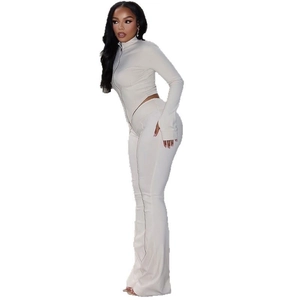Women's cream knit two-piece set featuring a zipped mock neck top and flared trousers