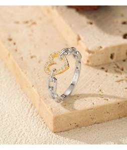 Macro detail of S925 silver chain ring with pavé heart and visible S925 stamp