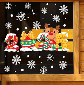 Close-up of 2025 New Year glass stickers with reindeer and snowflakes on a dark window