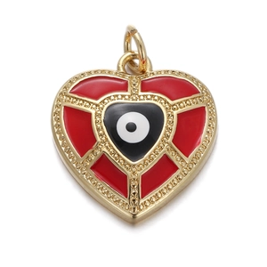 Macro detail of red heart pendant with evil eye motif and gold beaded edges