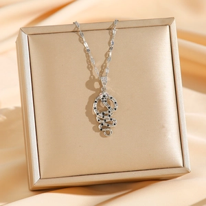 Elegant silver snake pendant necklace featuring black crystals and red gemstone eyes