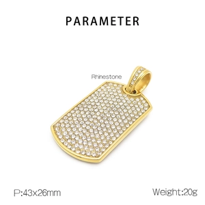 Macro view of gold dog tag pendant with rhinestone settings and size specifications